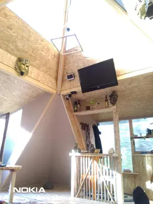 a room with a tv on the ceiling of a house at Pyramid in Visoko