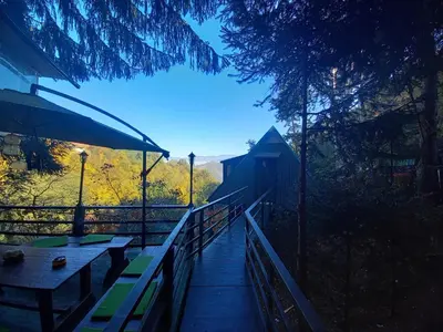a wooden walkway with picnic tables and an umbrella at Pyramid in Visoko