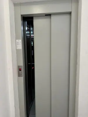 a glass door in a building with a window at Apartman CITY CENTER 1-šetalište in Prijedor