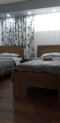a bedroom with two beds and a window at Apartments Jack in Bihać