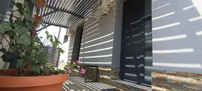 a porch with a potted plant and a window at Apartments Jack in Bihać