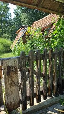 a wooden fence in front of a garden at BUNGALOV COZY UNA in Kulen Vakuf