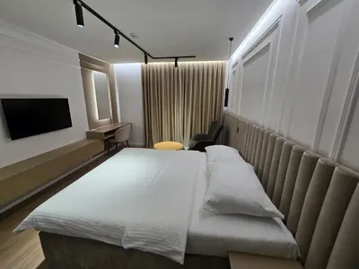 a hotel room with a bed and a tv at Hotel IN in Žepče
