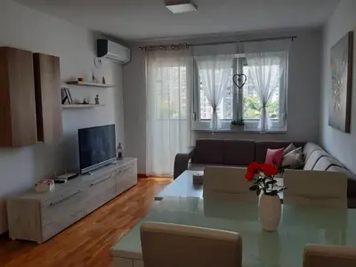 a living room with a couch and a table at Elena apartmani in Tuzla