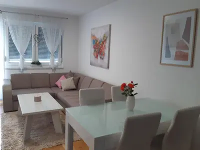 a living room with a couch and a table at Elena apartmani in Tuzla