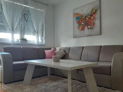 a living room with a couch and a table at Elena apartmani in Tuzla