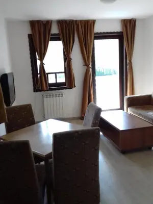 a living room with a table and chairs at Apartment Nice View in Fojnica