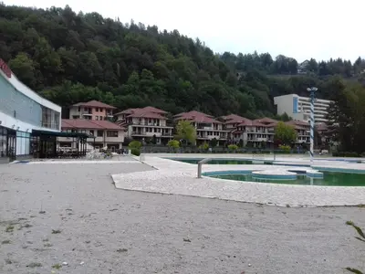 a resort with a pool in the middle of a town at Apartment Nice View in Fojnica