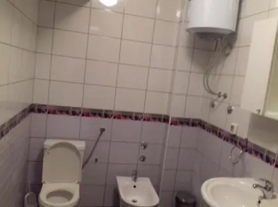 a small bathroom with a toilet and a sink at Apartment Nice View in Fojnica