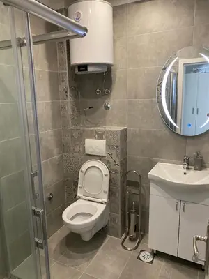 a bathroom with a toilet and a sink and a mirror at DMApartmani in Tuzla