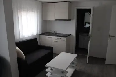 a small living room with a couch and a table at DMApartmani in Tuzla