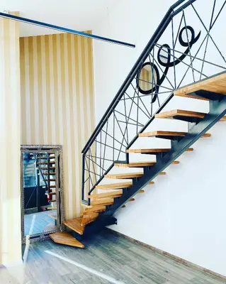 a spiral staircase in a room with a doorway at DM Sobe in Tuzla