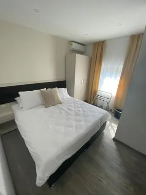a bedroom with a large white bed in a room at DM Sobe in Tuzla