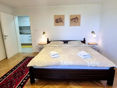 a bedroom with a bed with two towels on it at Apartman Alemina - mirna lokacija blizu centra, priroda i privatnost in Cazin