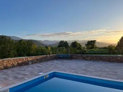 a swimming pool with a view of the mountains at Althea Home & Wellness in Bihać