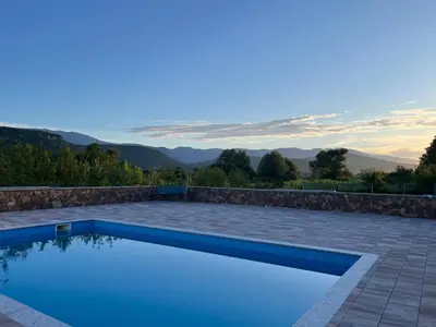 a swimming pool with a view of the mountains at Althea Home & Wellness in Bihać