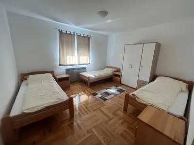 a small room with two beds and a cabinet at Althea Home & Wellness in Bihać