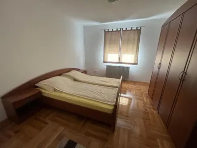 a small bedroom with a bed and a window at Althea Home & Wellness in Bihać