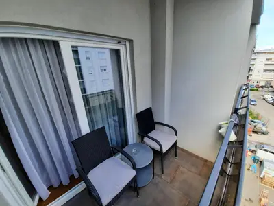 a balcony with two chairs and a window at CENTAR 2 BANJA LUKA in Banja Luka