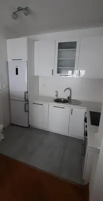 a white kitchen with a sink and a refrigerator at CENTAR 2 BANJA LUKA in Banja Luka