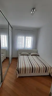 a bedroom with a bed and a large mirror at CENTAR 2 BANJA LUKA in Banja Luka