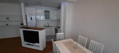 a kitchen with a tv and a table with chairs at CENTAR 2 BANJA LUKA in Banja Luka