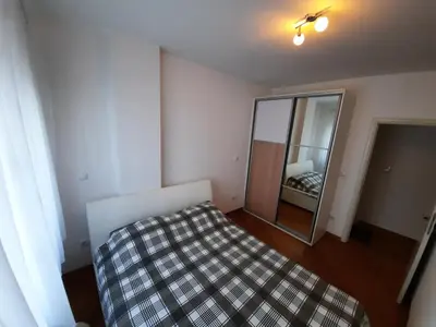 a small bedroom with a bed and a mirror at CENTAR 2 BANJA LUKA in Banja Luka
