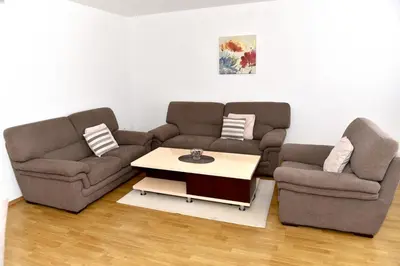 a living room with two couches and a coffee table at Sutjeska in Modriča