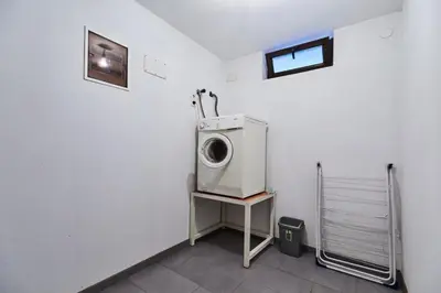 a laundry room with a washing machine on a table at Sutjeska in Modriča