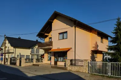 a building with a fence in front of it at Sutjeska in Modriča
