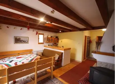 a bedroom with a bed and a couch in a room at Vlašićki Konak in Vlasic
