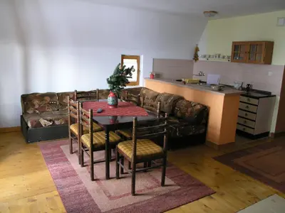 a living room with a table and a couch at Vlašićki Konak in Vlasic