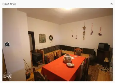a living room with a red table and a couch at Vlašićki Konak in Vlasic