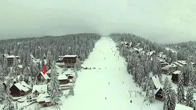 an aerial view of a village in the snow at Vlašićki Konak in Vlasic