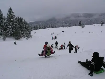 a group of people in the snow on a ski slope at Vlašićki Konak in Vlasic