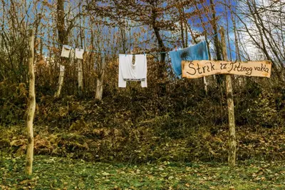 a sign that says start it flippinginky hanging on a clothes line at Etno Village Dolina Sreće in Vitez