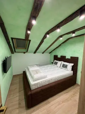 a bedroom with a bed and a tv in a room at Motel pizzeria Actros in Nova Topola