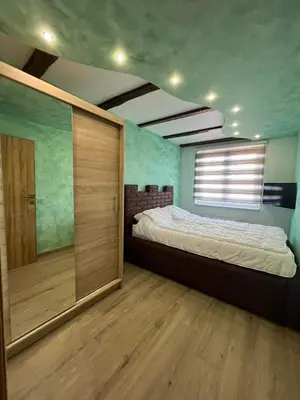 a bedroom with a large bed and a window at Motel pizzeria Actros in Nova Topola