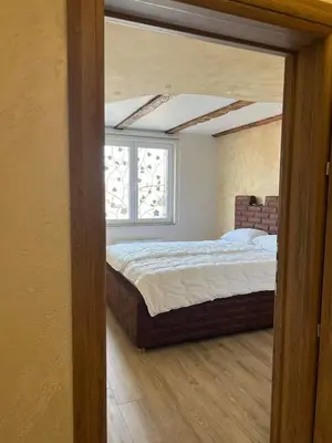 a bedroom with a large bed with a window at Motel pizzeria Actros in Nova Topola