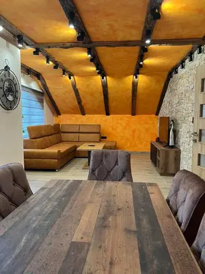 a room with a large wooden table and leather chairs at Motel pizzeria Actros in Nova Topola
