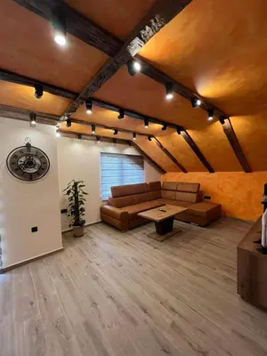 a living room with a couch and a table at Motel pizzeria Actros in Nova Topola