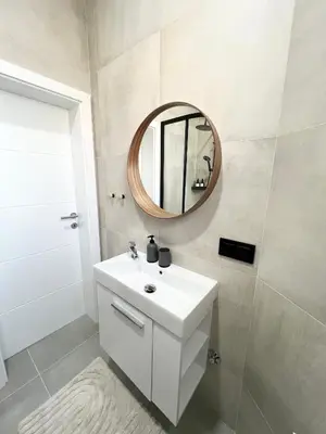a bathroom with a white sink and a mirror at Home Away From Home in Jajce
