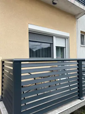 a blue fence in front of a window at Home Away From Home in Jajce