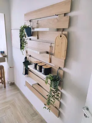 a wall with wooden dividers and potted plants at Apartman Lena in Tuzla