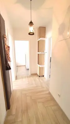 an empty hallway with wooden floors in a apartment at Apartman Lena in Tuzla