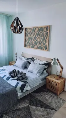 a bedroom with a bed and a pendant light at Apartman Lena in Tuzla