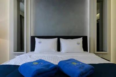 two blue towels sitting on top of a bed at Hotel Terme Ozren in Bosansko Petrovo Selo