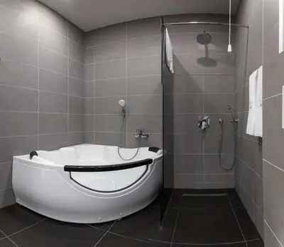 a bathroom with a bath tub and a shower at Hotel Terme Ozren in Bosansko Petrovo Selo