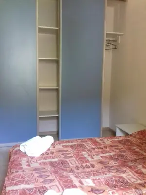 a bedroom with a bed and a book shelf at Street View Apartman in Fojnica