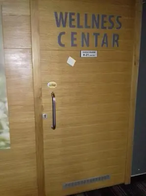 a wooden door with the wellness center written on it at Street View Apartman in Fojnica